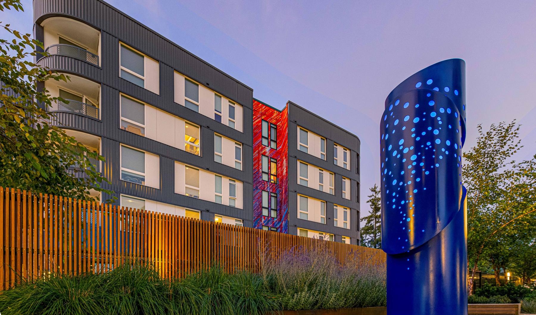 a blue statue in front of a building