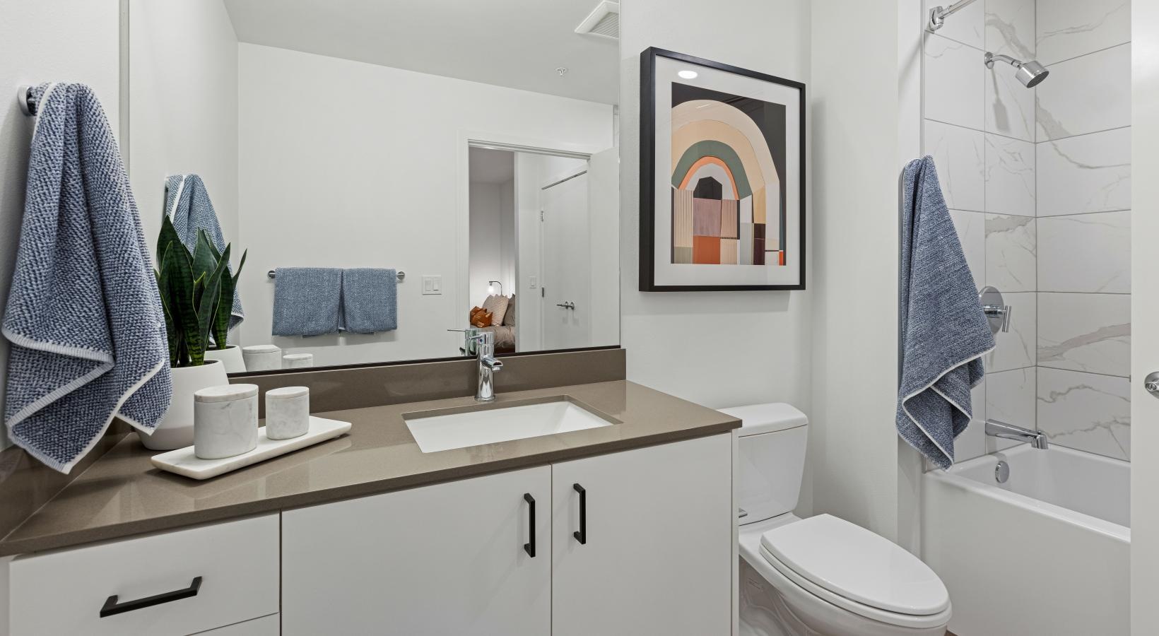 Spacious bathrooms with everything you need a bathroom with a sink toilet and a mirror