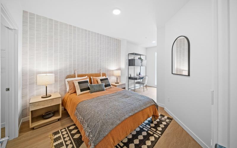 a bedroom with a bed and a mirror