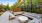 a patio with a fence and a patio with a table and chairs