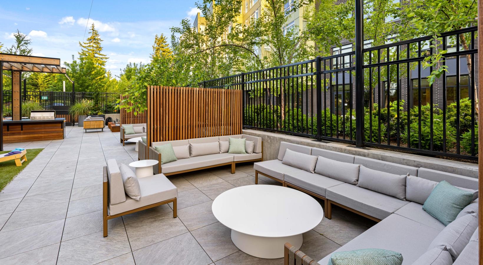 Access to resident-only features a patio with a fence and a patio with a table and chairs