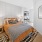 a bedroom with a bed and a mirror