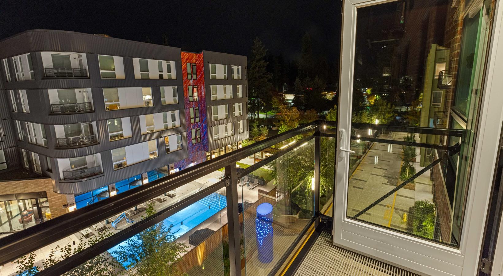 Sparkling swimming pool a building with a pool and a deck with a view of the city